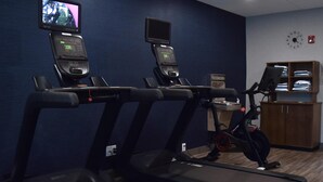 A gym with treadmills, a stationary bike, and a television mounted on the wall. - Hampton Inn Frankfort (Frankfort)