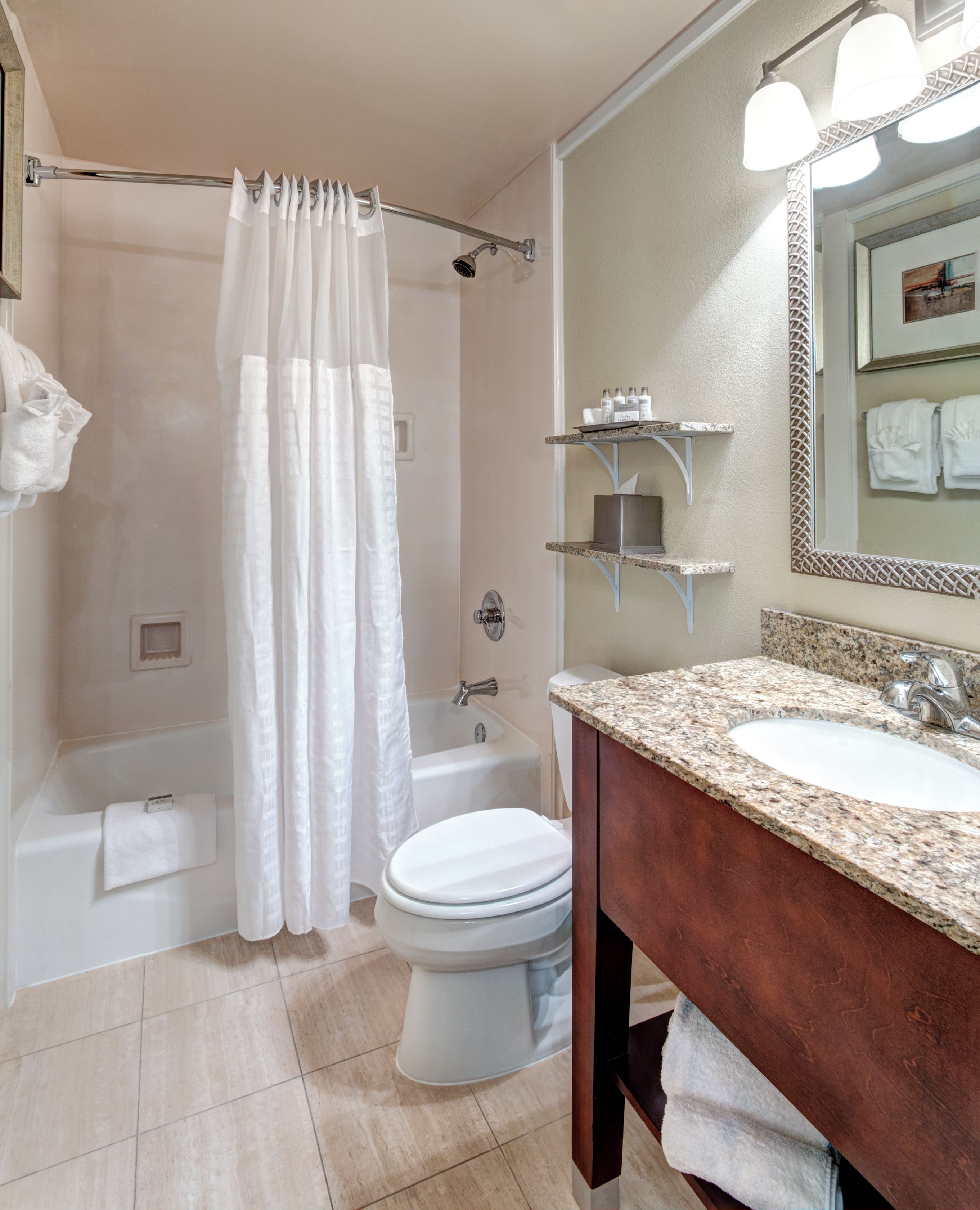 A bathroom with a bathtub, toilet, and sink.