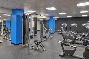 A gym with various exercise equipment, including treadmills, weight machines, and dumbbells. - Courtyard by Marriott Denver Downtown (Denver)