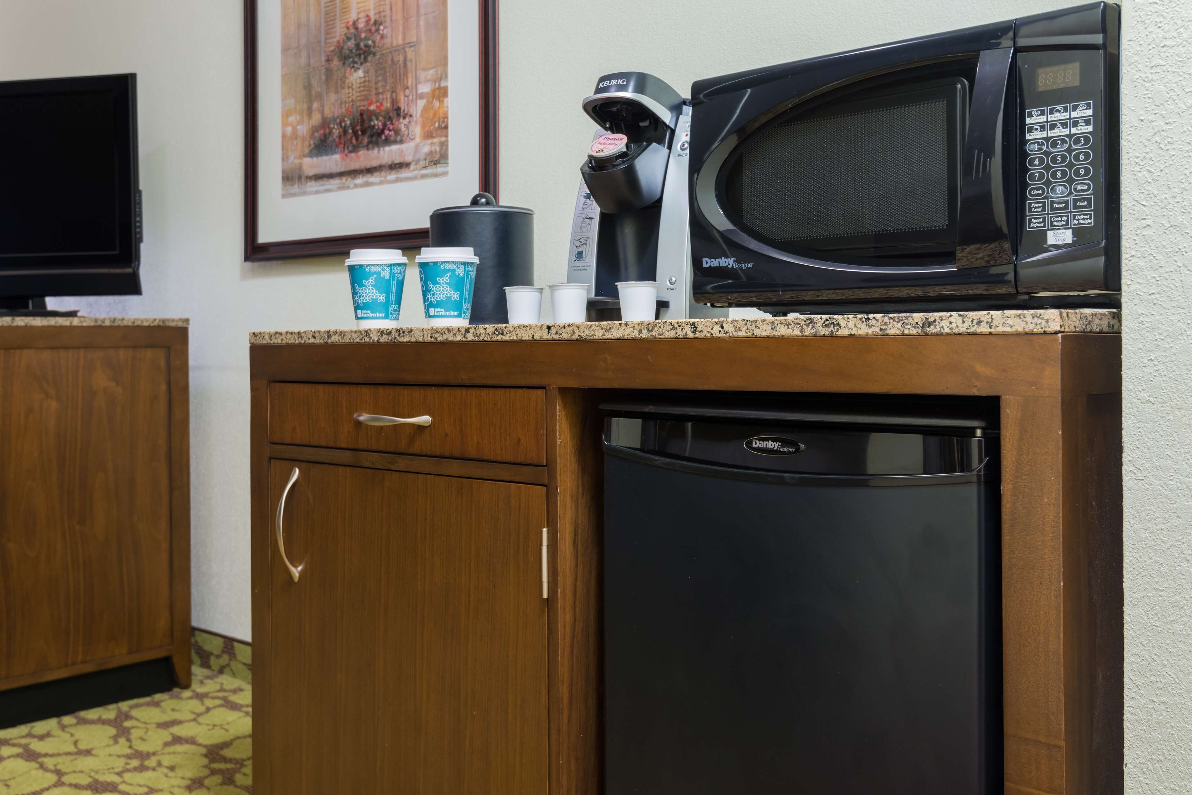 A kitchen with a microwave, coffee maker, and dishwasher.
