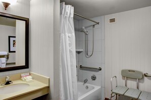 A bathroom with a sink, mirror, shower, and grab bars. - Hilton Garden Inn Atlanta North/Alpharetta (Alpharetta)