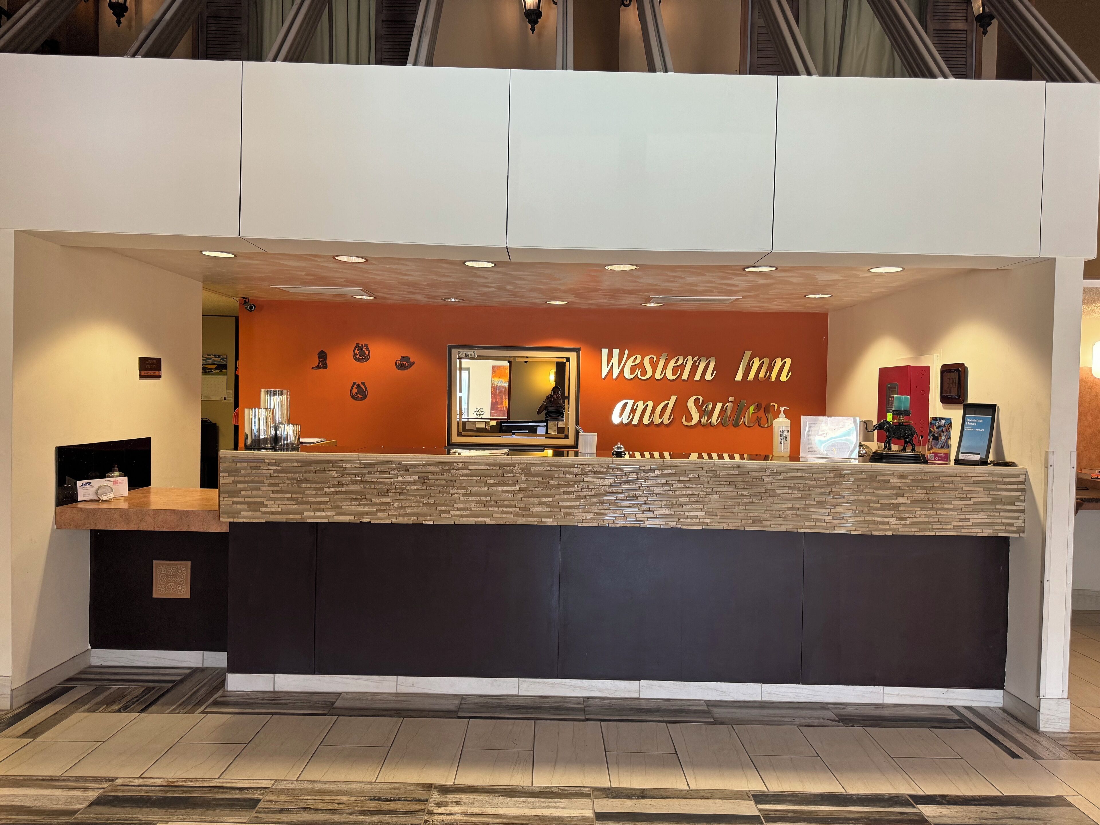 A reception desk with a sign reading "Western Inn and Suites".