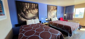 A hotel room with two beds, a nightstand, a lamp, and artwork on the walls. - Super 8 by Wyndham Cleburne (Cleburne)