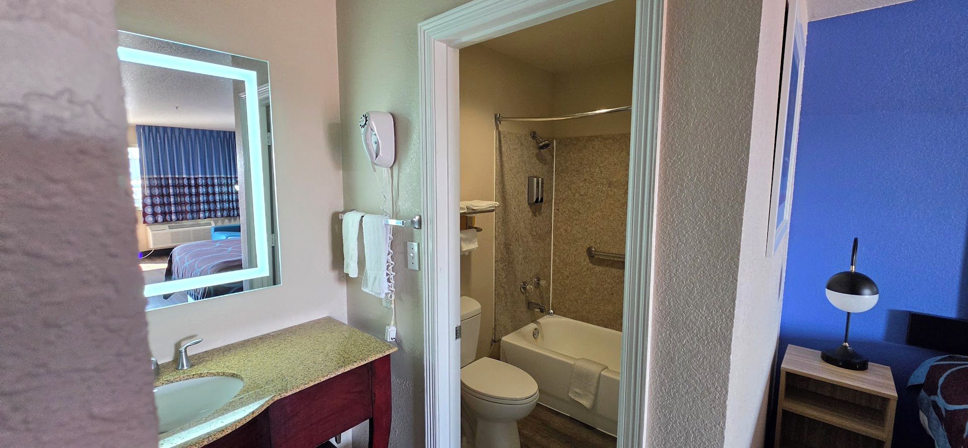 A bathroom with a sink, toilet, and shower.