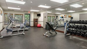 A gym with exercise equipment, a red exercise ball, and a rack of dumbbells. - Comfort Inn & Suites Dahlonega University Area (Dahlonega)