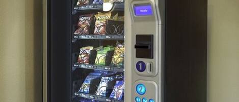 A vending machine with snacks and a keypad.