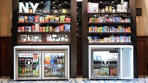 A vending machine area with snacks, drinks, and personal items. - Hampton Inn & Suites Rochester/Victor (Victor)