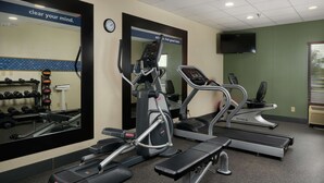 A gym with treadmills, a mirror, and a wall clock. - Hampton Inn Franklin (Franklin)