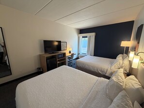 A hotel room with two beds, a television, a desk, and a window with curtains. - Spark by Hilton Franklin (Franklin)