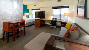 A hotel room with a bed, a desk, a TV, a sofa, and a chair. - Residence Inn by Marriott Minneapolis St. Paul/Roseville (Roseville)