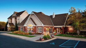 A two-story brick building with a large entrance and a parking lot with handicapped spaces. - Residence Inn by Marriott Minneapolis St. Paul/Roseville (Roseville)