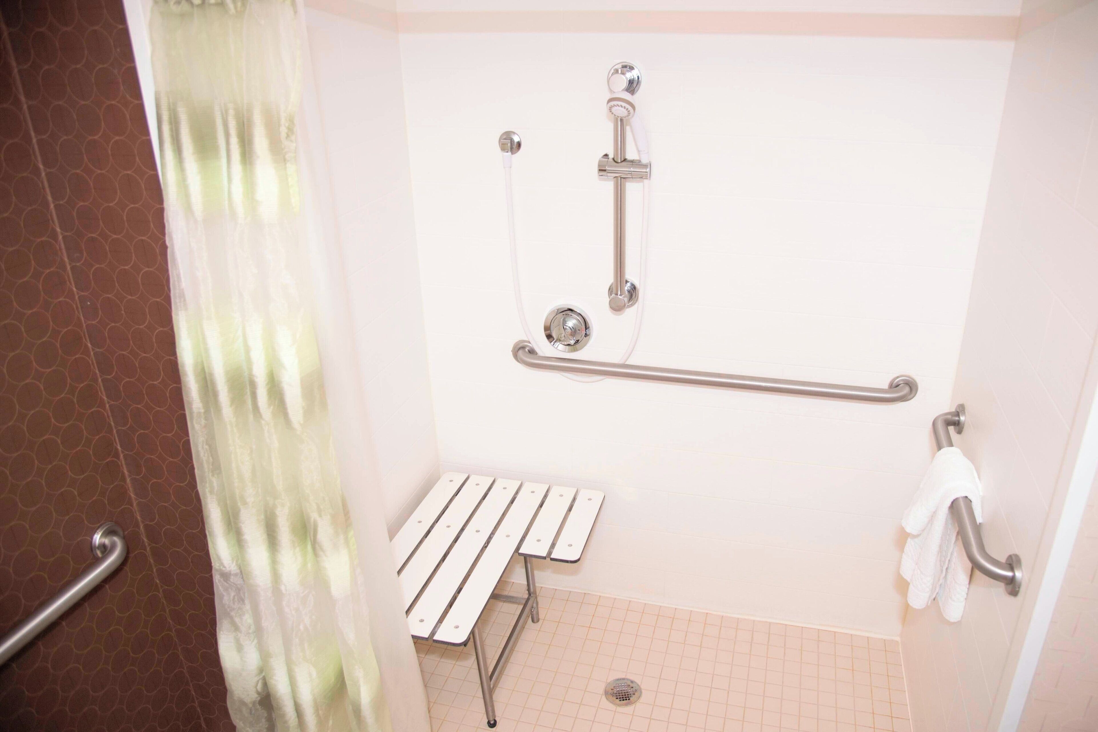 combined shower/bathtub, designer toiletries, hair dryer, towels