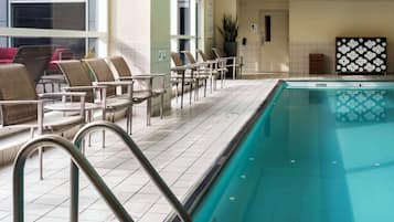 Relax by the pool, surrounded by lounge chairs and a safe, tiled area.