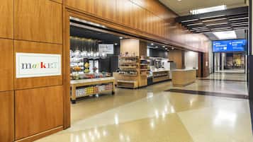 A market area with shelves stocked with various products, a sign indicating a market, and a McCormick Place sign in the background.
