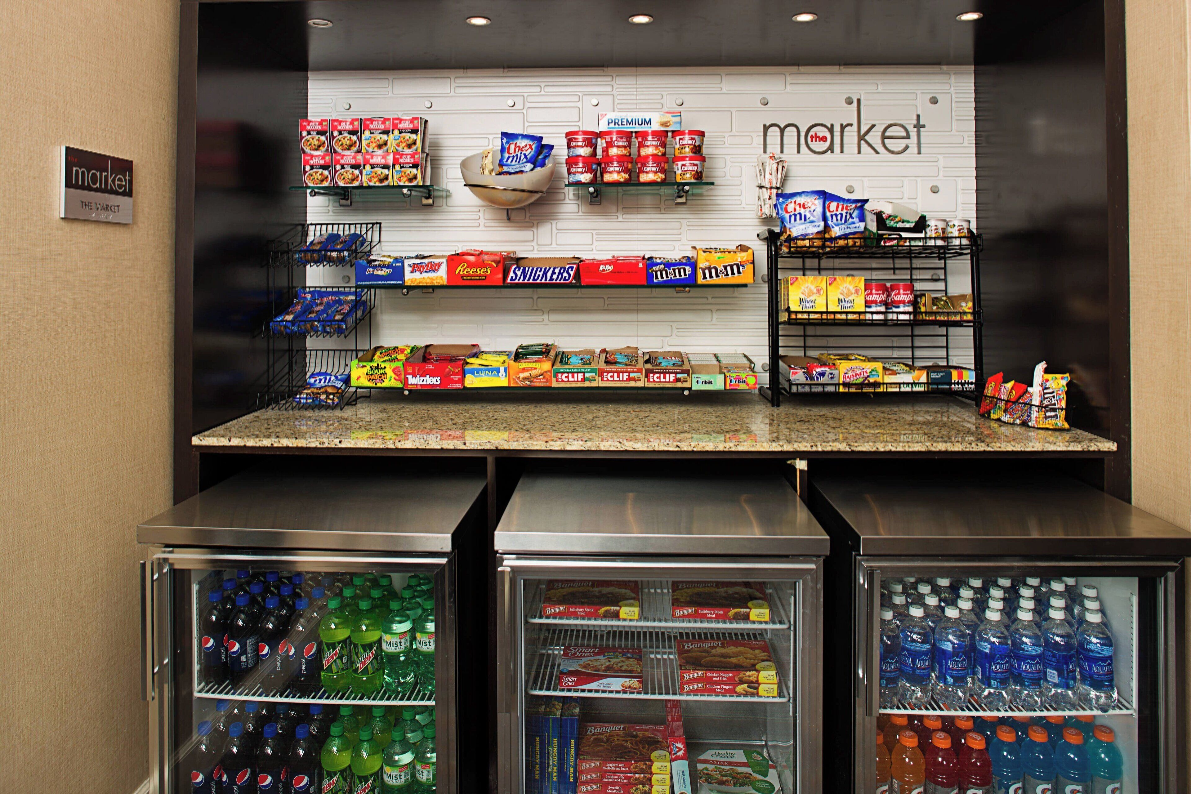 A snack display in a store with various packaged snacks and beverages.