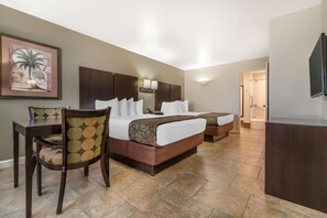 A hotel room with a large bed, a desk, a chair, and a television. - Best Western Padre Island (Corpus Christi)