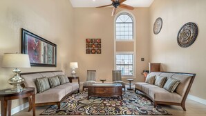 A living room with a sofa set, coffee table, and decorative items.