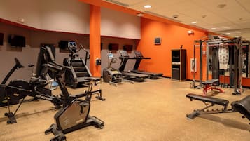 A gym with treadmills, ellipticals, and weight machines.