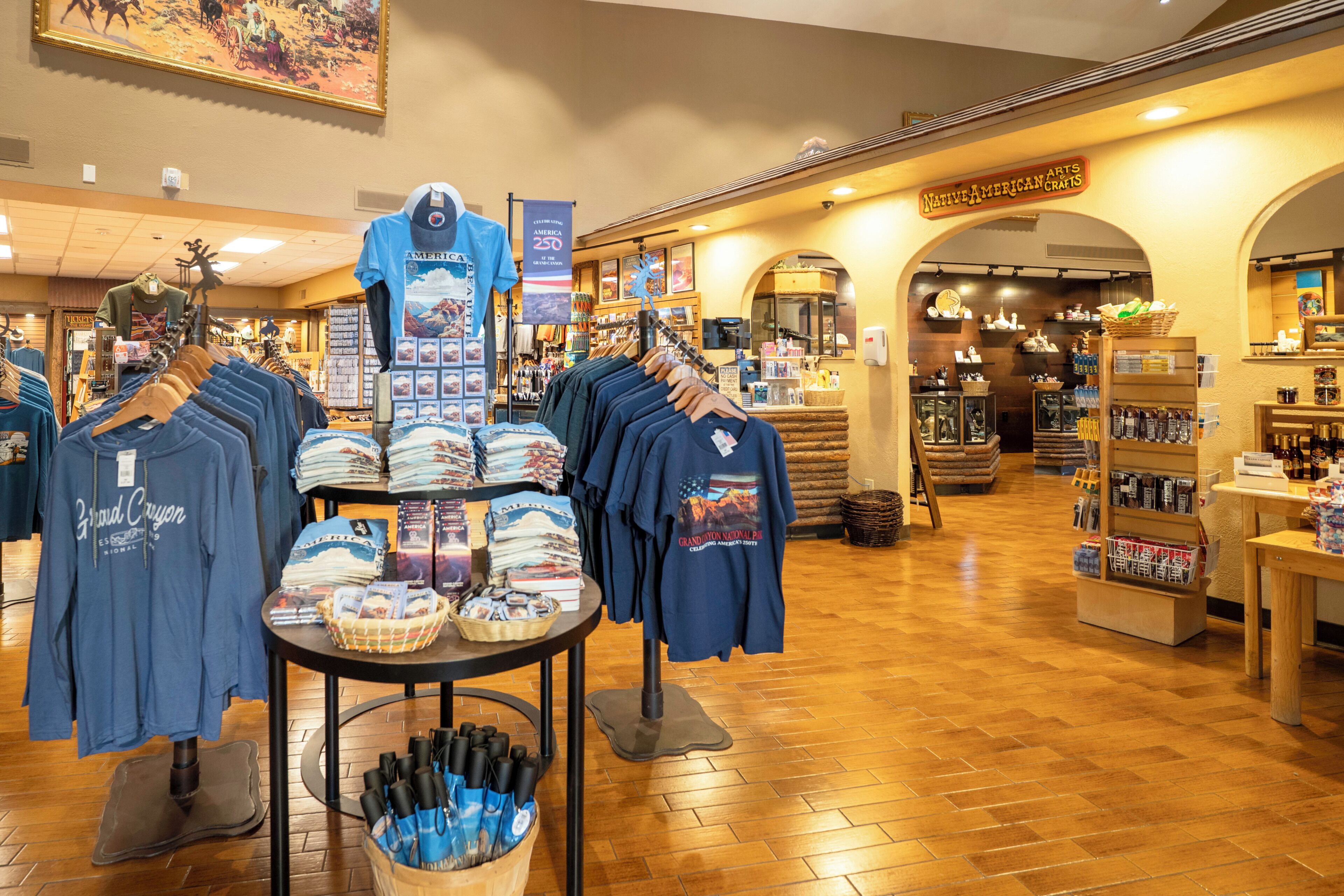 A retail store with clothing and souvenirs, wooden floors, and a sign for Native American crafts.