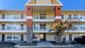 A multi-story hotel with a central atrium, balconies, and a parking lot. - Extended Stay America Select Suites Roanoke Airport (Roanoke)