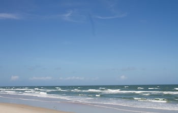 On the beach, beach umbrellas at Grand Seas by Exploria Resorts