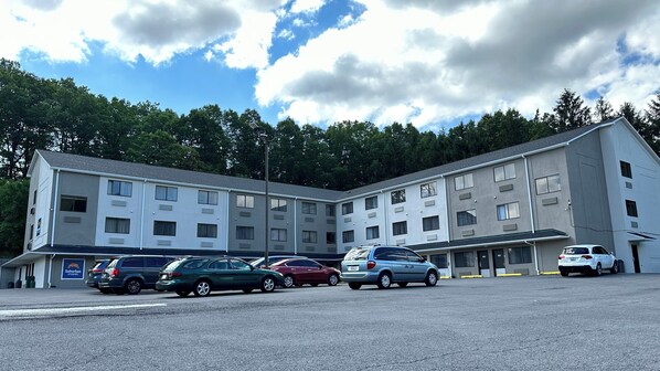A multi-story motel with a parking lot.