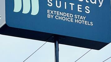 A MainStay Suites signboard with a clear view of the hotel name and the phrase "Extended Stay by Choice Hotels".