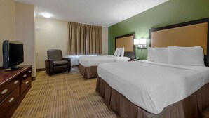 A hotel room with two beds, a TV, a chair, and a desk. - Extended Stay America Select Suites - Orlando - Conven Ctr - Sports Complex (Orlando)