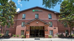 A brick building with a green logo and the text "extended STAY AMERICA" on the facade. - Extended Stay America Suites Tallahassee Killearn (Tallahassee)