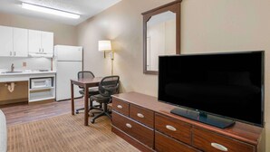 A hotel room with a kitchenette, a dining area, a TV, and a large mirror. - Extended Stay America Suites Richmond W Broad St Glenside S (Richmond)