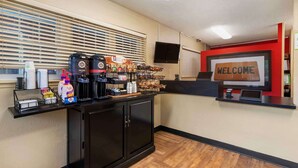 A reception area with a coffee station, a welcome sign, and a counter with a computer. - Extended Stay America Suites Richmond W Broad St Glenside S (Richmond)
