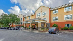 A hotel with a covered lobby, numbered 304, and a parking lot with several cars. - Extended Stay America Suites Charleston Mt Pleasant (Mount Pleasant)