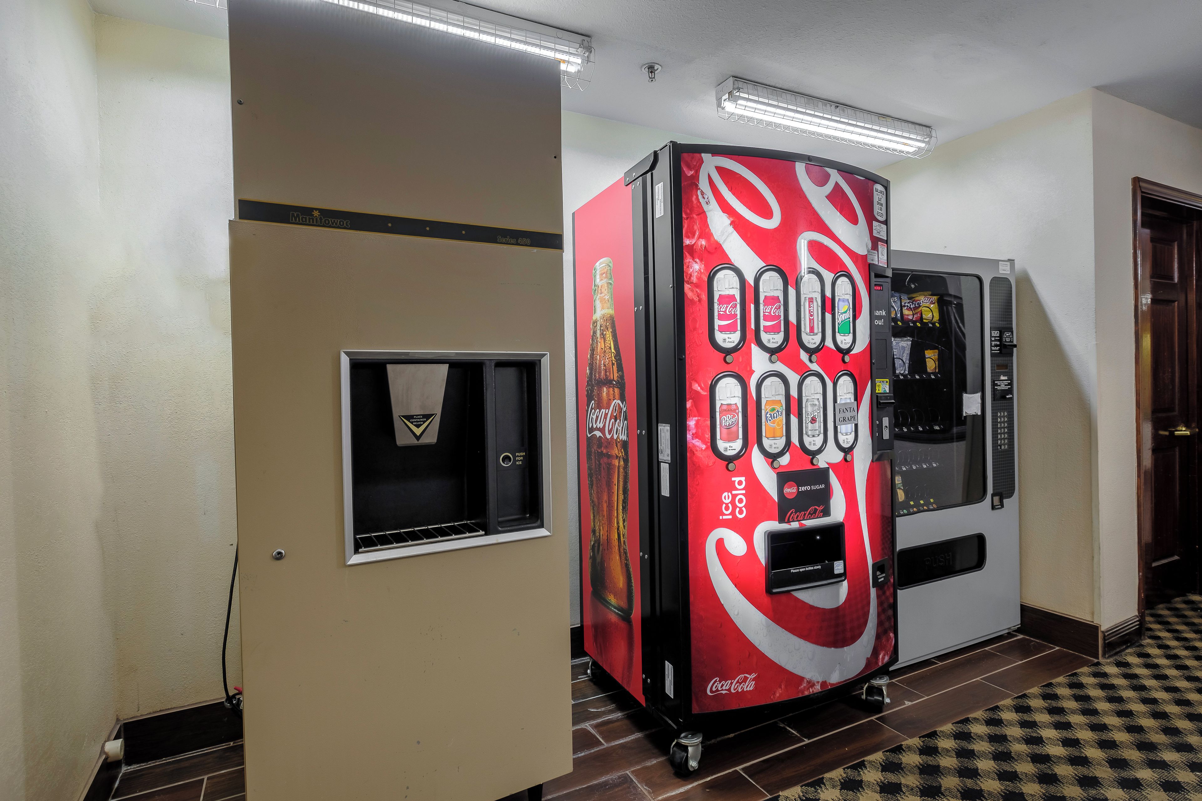 A vending machine with a Coca-Cola logo, a drink dispenser, and a soda fountain.