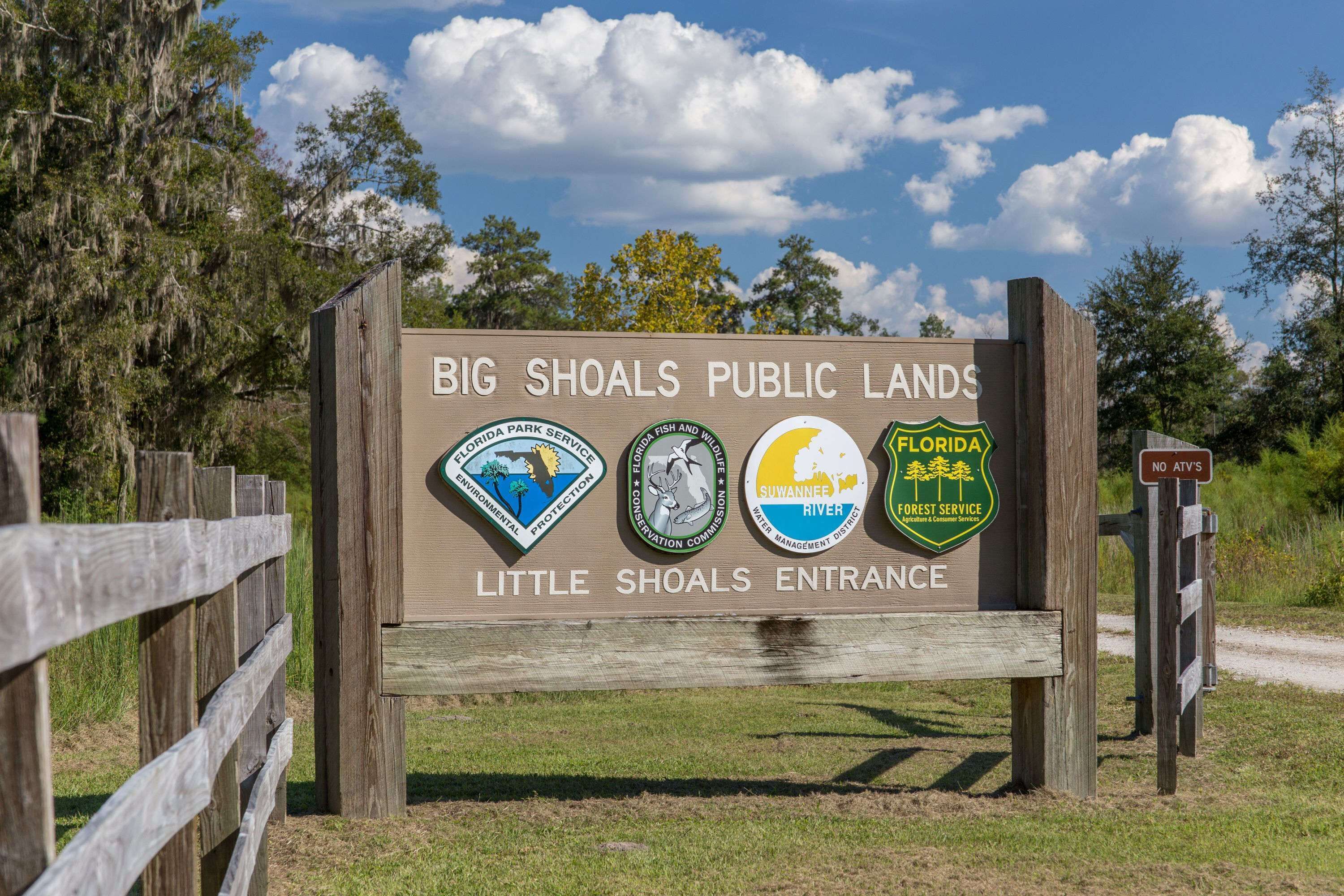A sign for Big Shoals Public Lands with logos of various Florida state and environmental agencies.