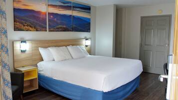 A neatly made bed with a wooden headboard, a bedside table, and a wall-mounted lamp.