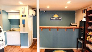 A reception area with a 'Days Inn' sign, a small kitchenette, and a snack bar. - Days Inn by Wyndham Little River (Little River)