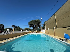 Outdoor pool, open 8:00 AM to 9:00 PM, pool umbrellas