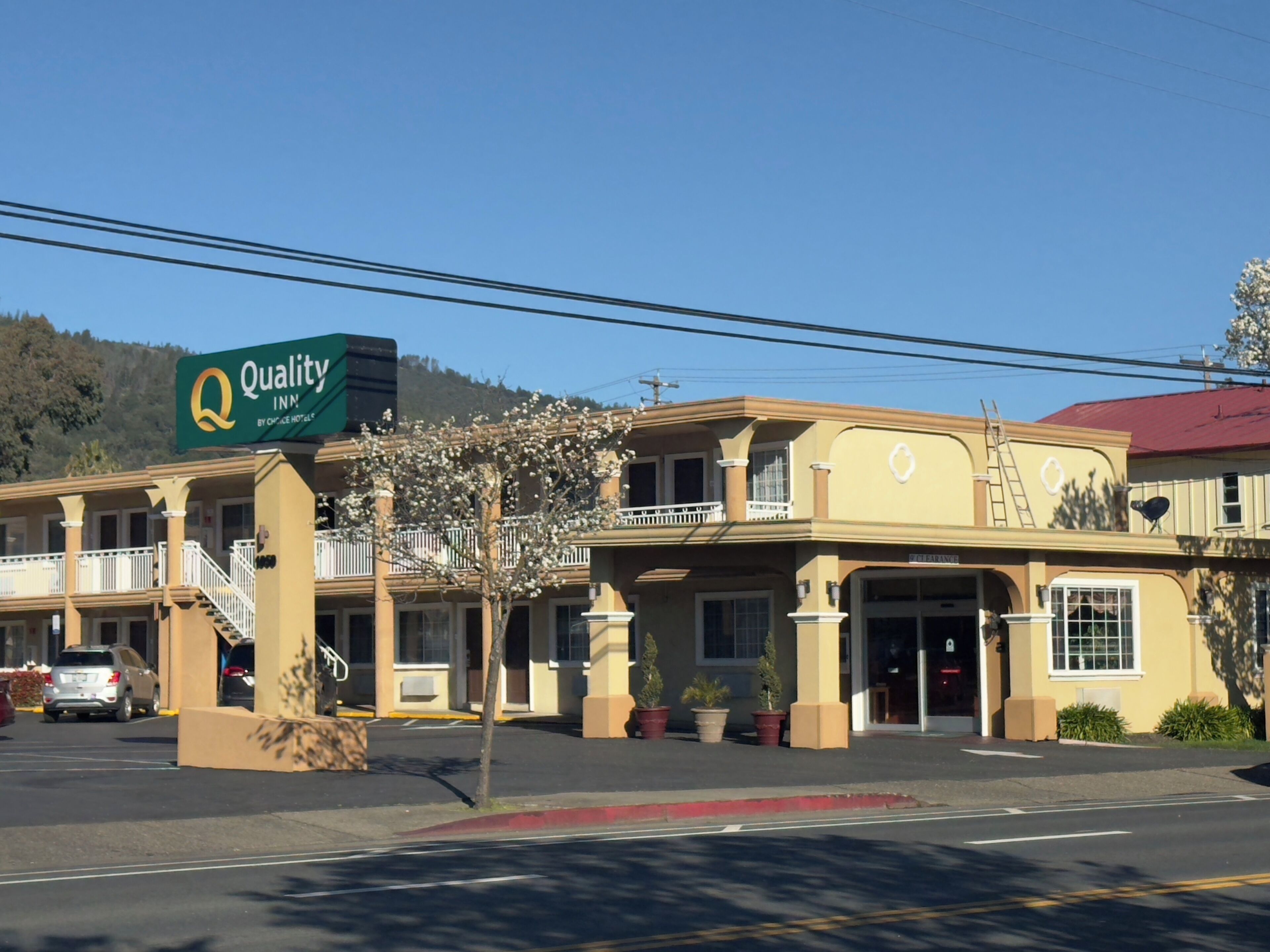 A two-story motel with a sign reading "Quality Inn By Choice Hotels."
