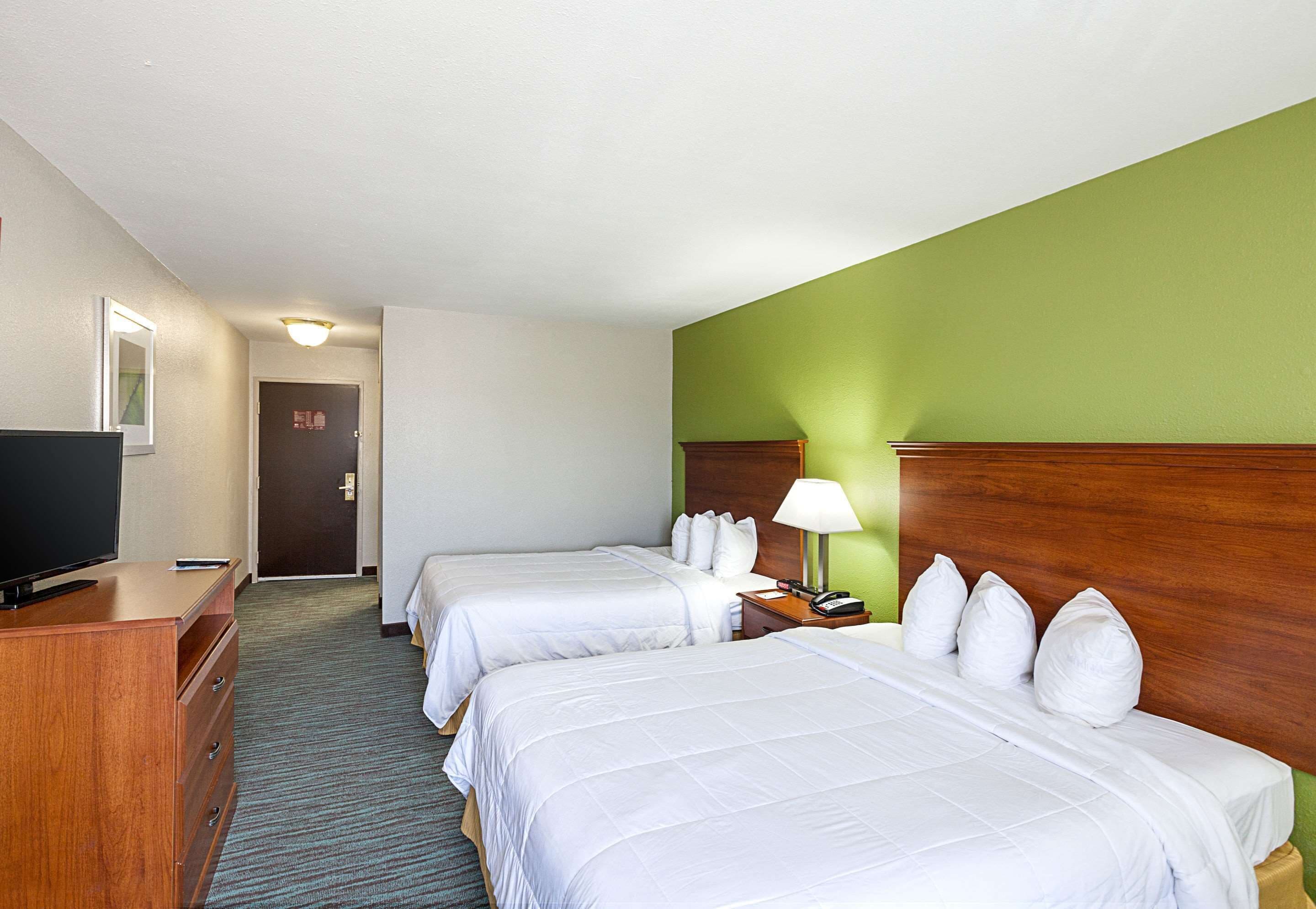 Hypo-allergenic bedding, desk, laptop workspace, blackout drapes