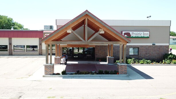 A Prairie Inn with a covered entrance and brick facade. - Prairie Inn (Vermillion)