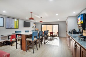 A modern kitchen with granite countertops, wooden cabinets, and a built-in oven. - Comfort Inn Livingston (Livingston)