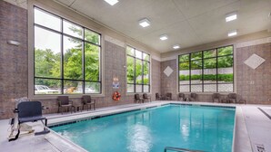 A large indoor swimming pool with clear windows, chairs, and a lifebuoy. - Comfort Suites Boone - University Area (Boone)