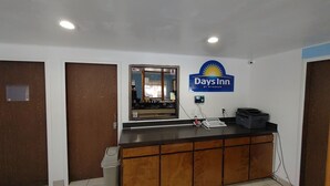A reception desk with a Days Inn sign, a computer, and a telephone. - Days Inn by Wyndham Pocatello University Area (Pocatello)
