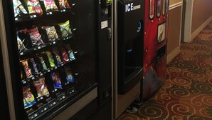 A vending machine with snacks and a Coca-Cola dispenser in a hotel hallway. - Days Inn by Wyndham Pocatello University Area (Pocatello)