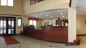 A reception area with a wooden reception desk, a red carpet, and a door marked "EXIT".