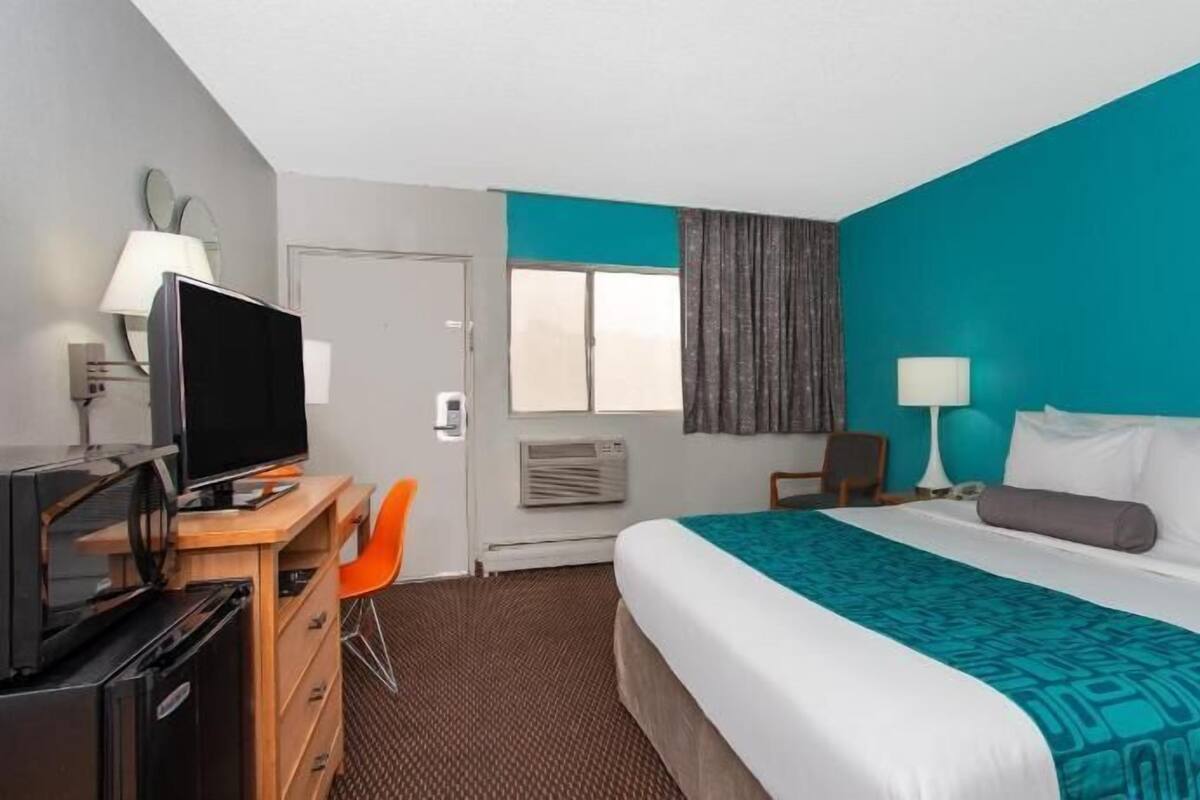 Premium bedding, desk, laptop workspace, blackout curtains