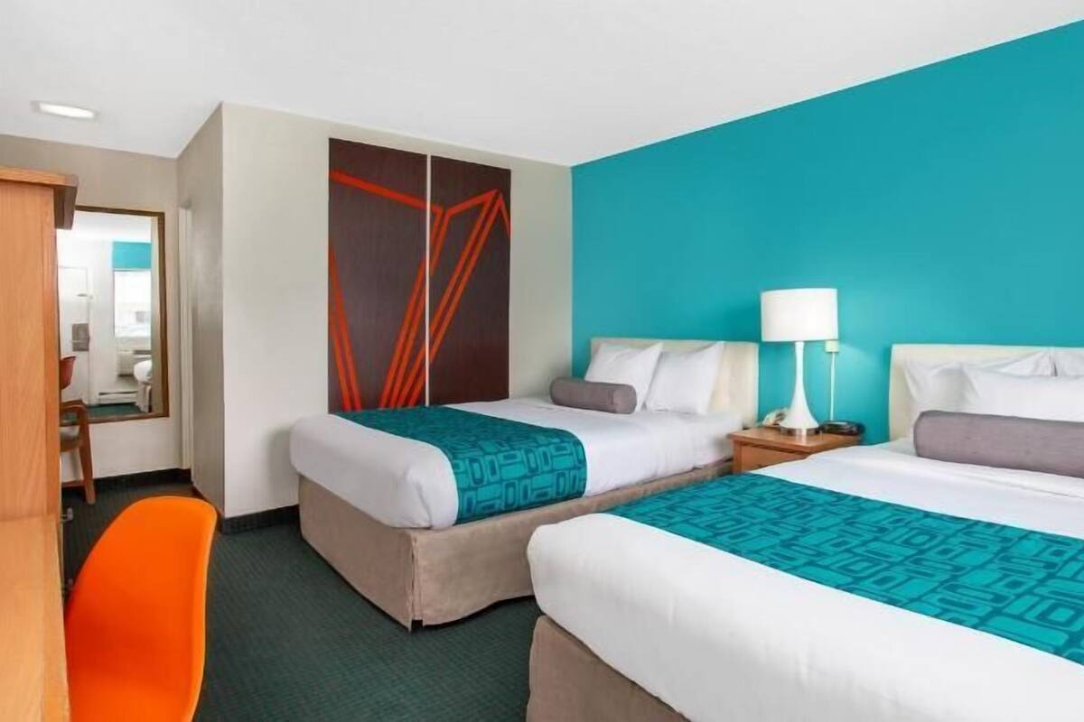 Premium bedding, desk, laptop workspace, blackout curtains