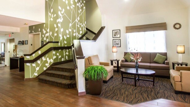 A spacious lobby with a modern staircase, a comfortable seating area, and a large window providing natural light. - Sleep Inn North Scottsdale near Mayo Clinic (Scottsdale)