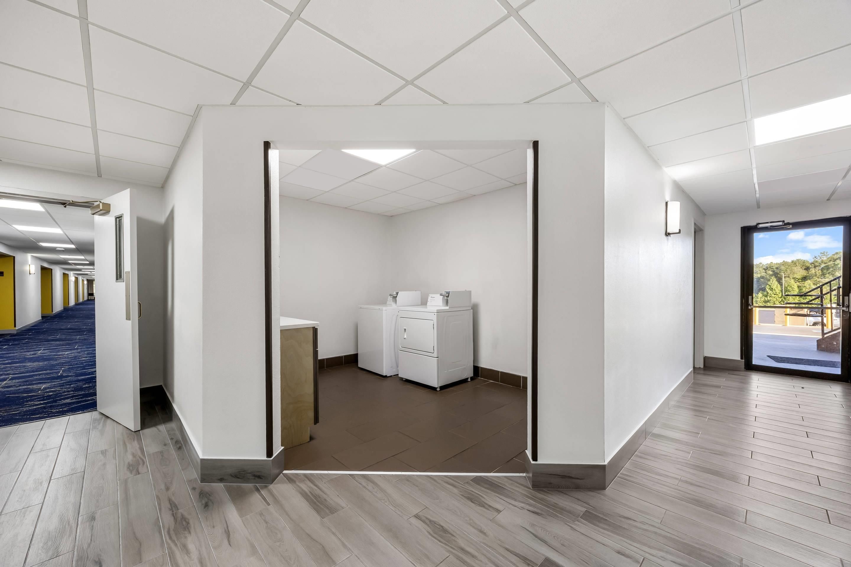 A clean, modern laundry facility with a view of the parking area.