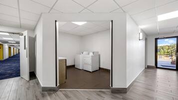 A clean, modern laundry facility with a view of the parking area.
